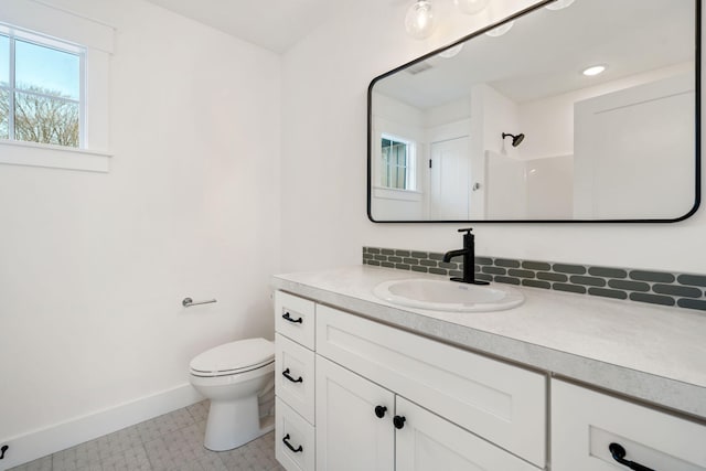 bathroom featuring vanity, visible vents, baseboards, recessed lighting, and toilet