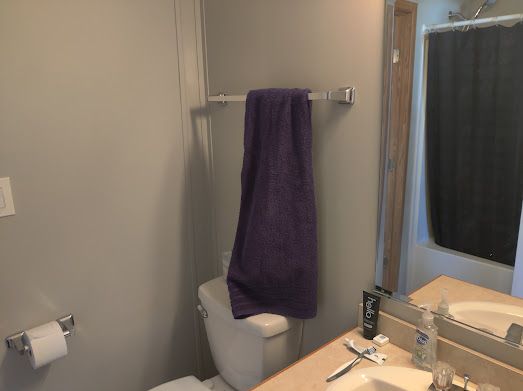 bathroom with a shower with shower curtain and toilet