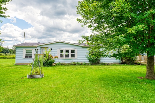 rear view of property featuring a yard