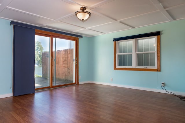 empty room featuring dark wood-type flooring and coffered ceiling