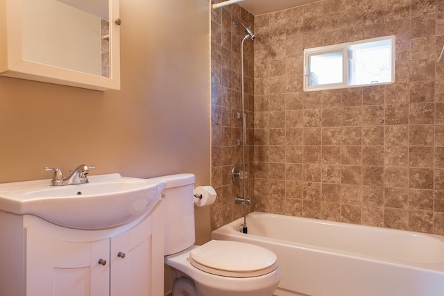 full bathroom with vanity, toilet, and tiled shower / bath combo