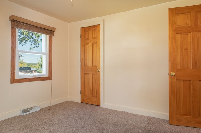 unfurnished room with light colored carpet