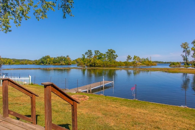 view of dock featuring a yard and a water view