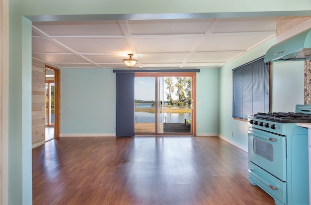 kitchen featuring high end range, dark hardwood / wood-style flooring, a water view, and exhaust hood