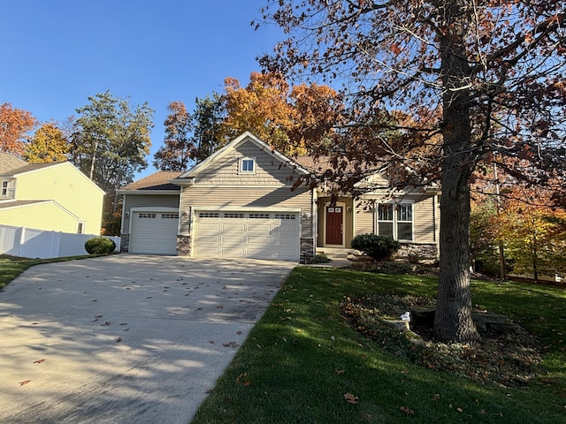 craftsman house with a garage and a front lawn