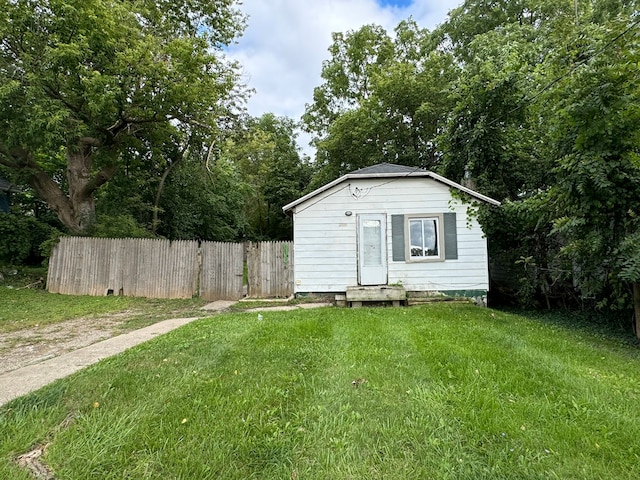 view of outbuilding featuring a lawn