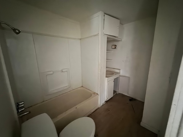 bathroom with toilet, vanity, and hardwood / wood-style flooring