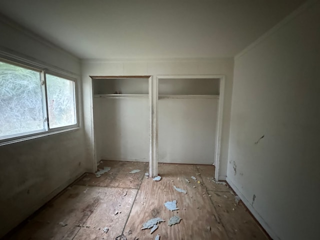 unfurnished bedroom with two closets