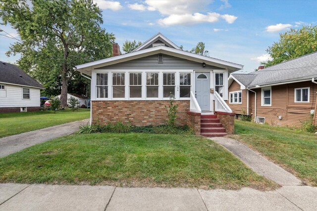 bungalow-style house with a front lawn