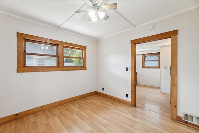 unfurnished room featuring ceiling fan, light hardwood / wood-style floors, and ornamental molding