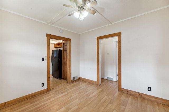 unfurnished room with ceiling fan and light wood-type flooring