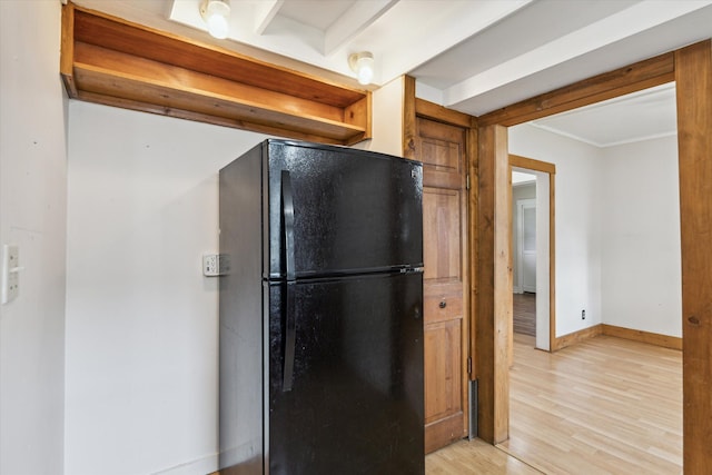 kitchen featuring black refrigerator and light hardwood / wood-style flooring