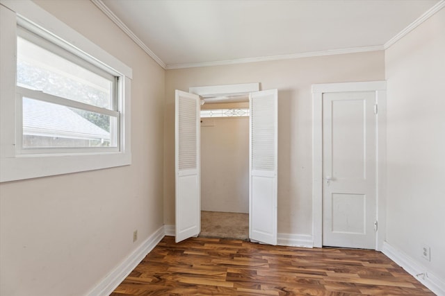 unfurnished bedroom featuring a closet, ornamental molding, and dark hardwood / wood-style floors