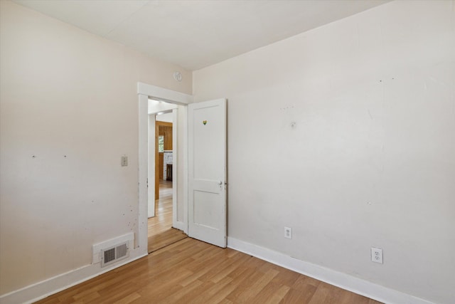 spare room with light hardwood / wood-style floors