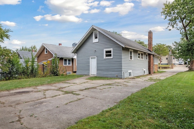 view of property exterior with a yard