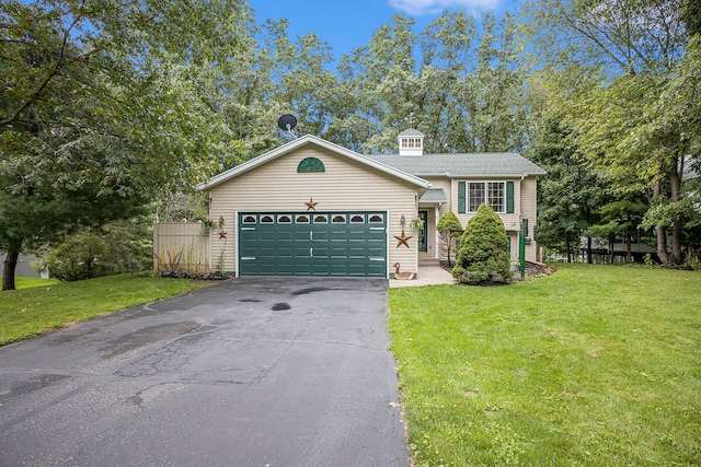 view of front of house featuring a garage and a front lawn