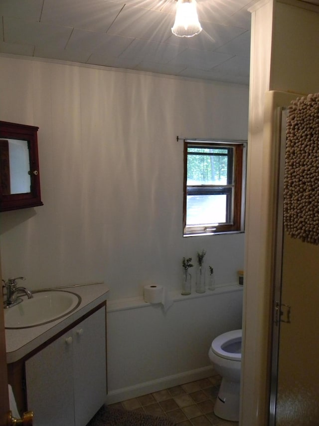 bathroom with a shower with curtain, tile patterned flooring, vanity, and toilet