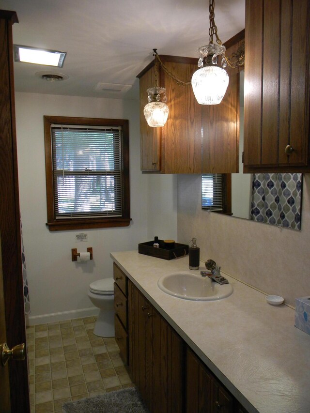 115 S Emerson Dr, Branch, MI 49402 - bathroom with vanity, toilet, and baseboards