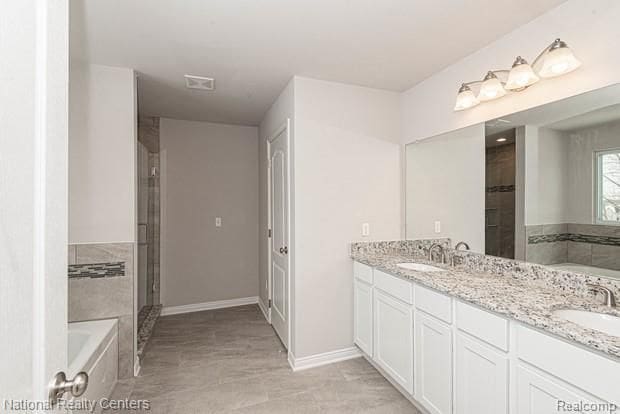 bathroom with vanity and separate shower and tub