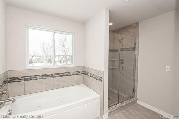 bathroom featuring shower with separate bathtub