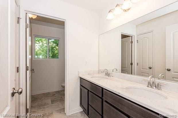 bathroom with vanity and toilet