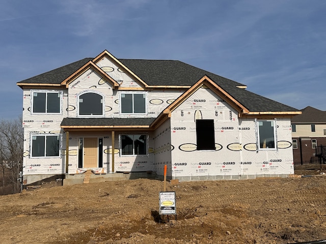 property in mid-construction featuring roof with shingles