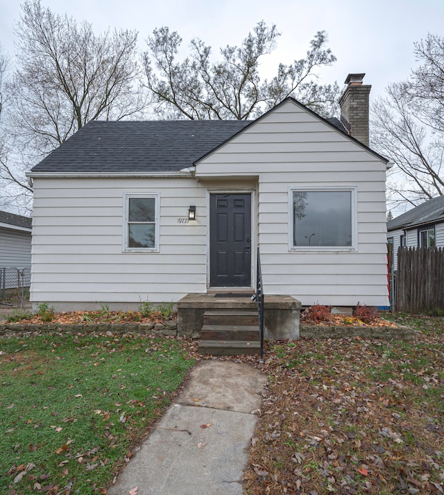 bungalow-style home featuring a front yard