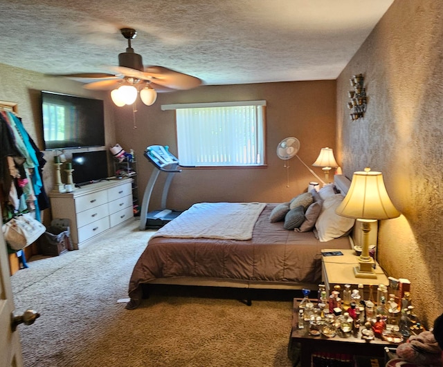 carpeted bedroom with a textured ceiling, multiple windows, and ceiling fan