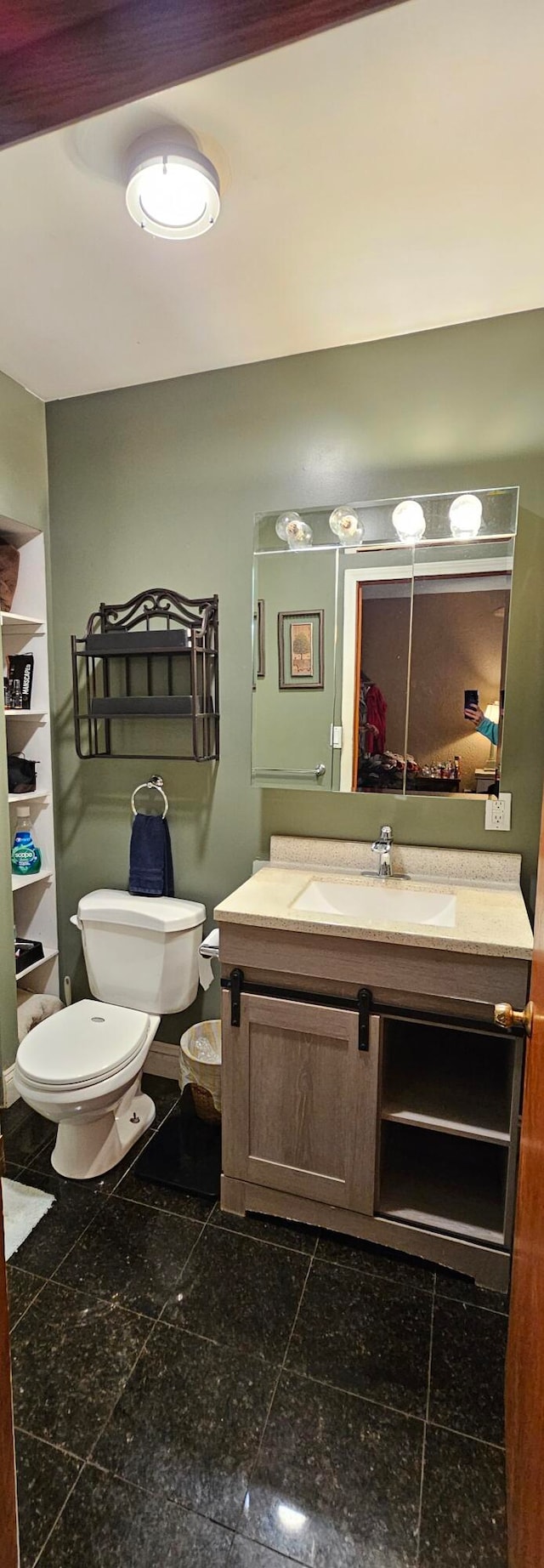 bathroom featuring vanity and toilet