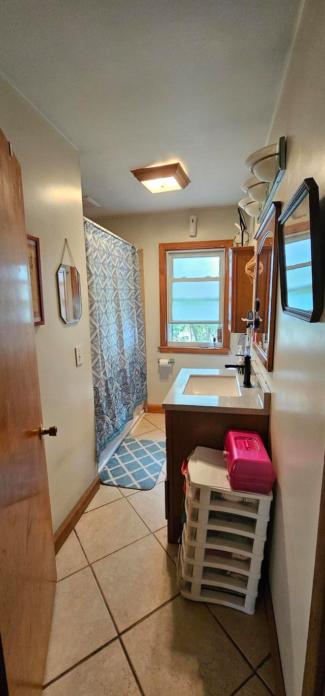 bathroom with tile patterned flooring and vanity