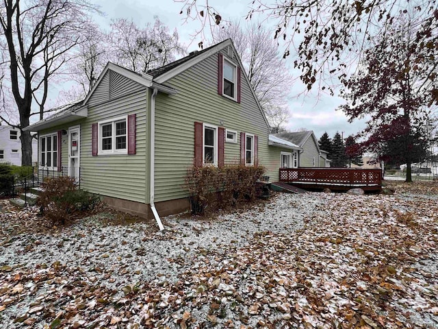 view of snowy exterior with a deck