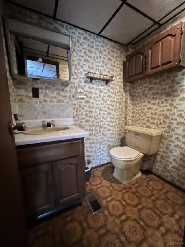 bathroom with toilet and vanity