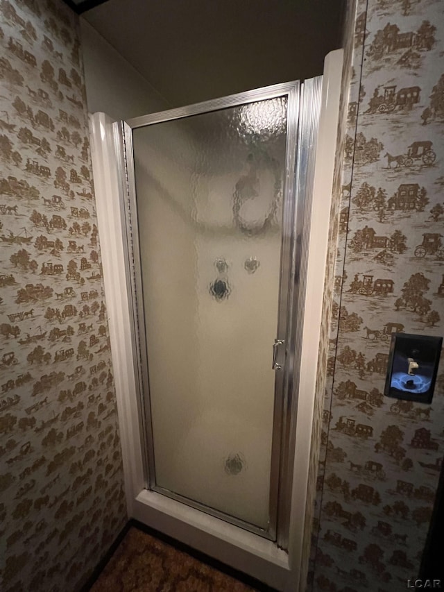 bathroom with a shower with door