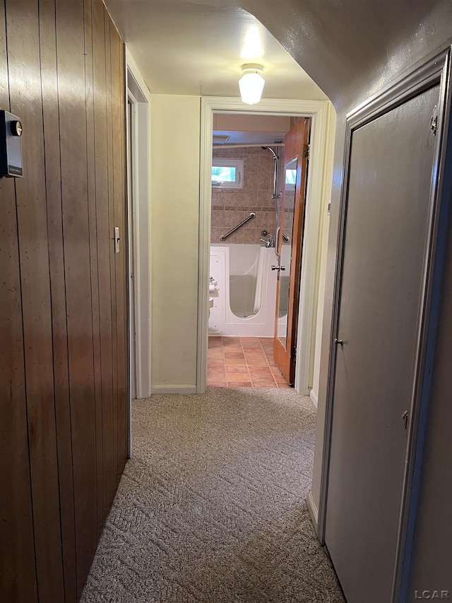 hallway featuring light colored carpet