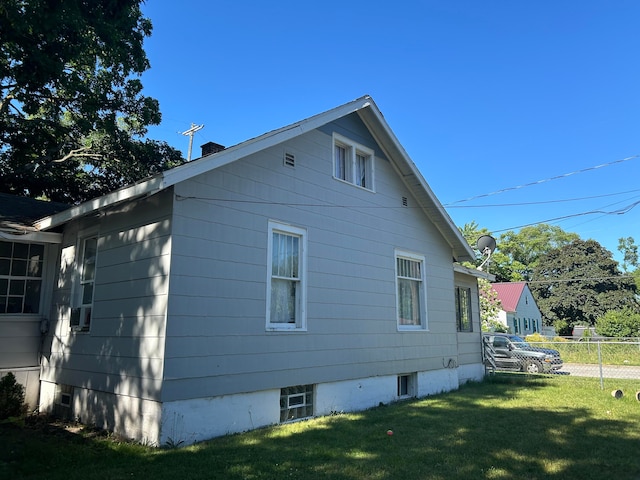 view of side of home featuring a yard