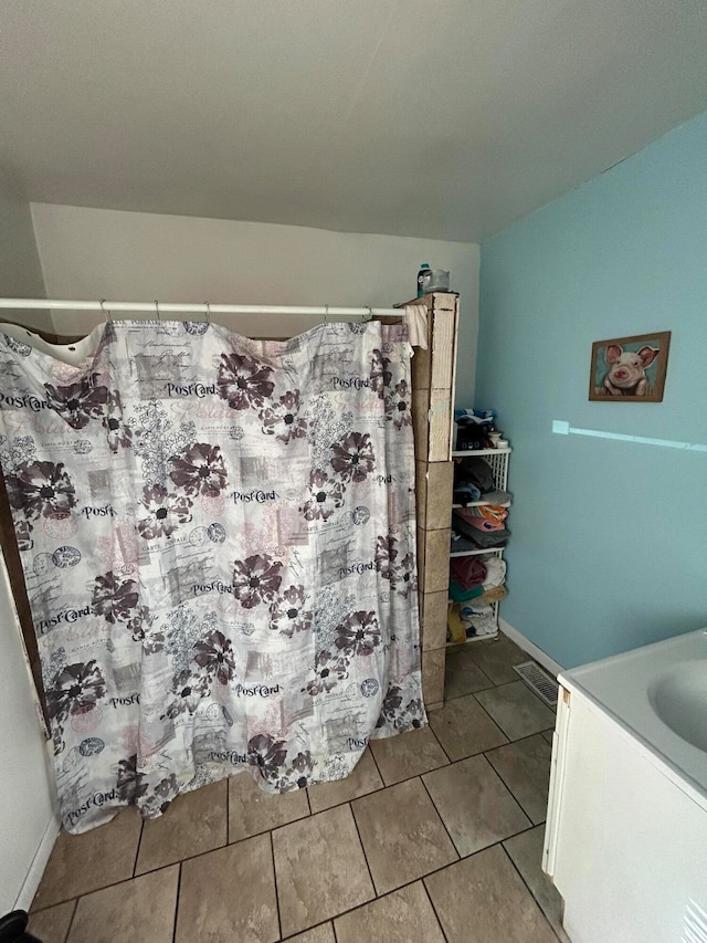 bathroom with tile patterned floors and vanity