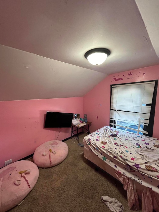 unfurnished bedroom with carpet and lofted ceiling