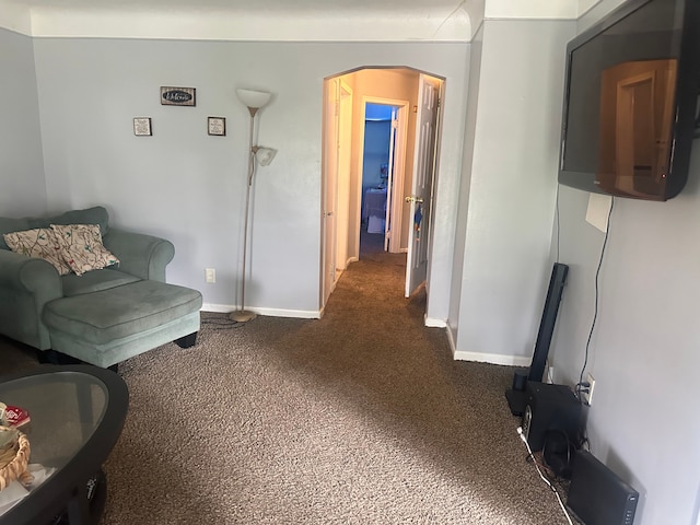 sitting room with dark colored carpet