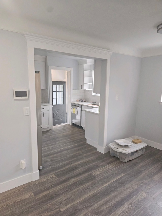 interior space with backsplash, dishwasher, and dark wood-type flooring