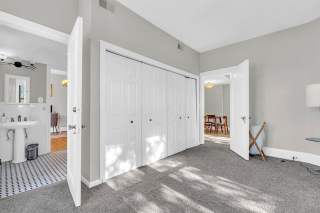 unfurnished bedroom featuring carpet and a closet