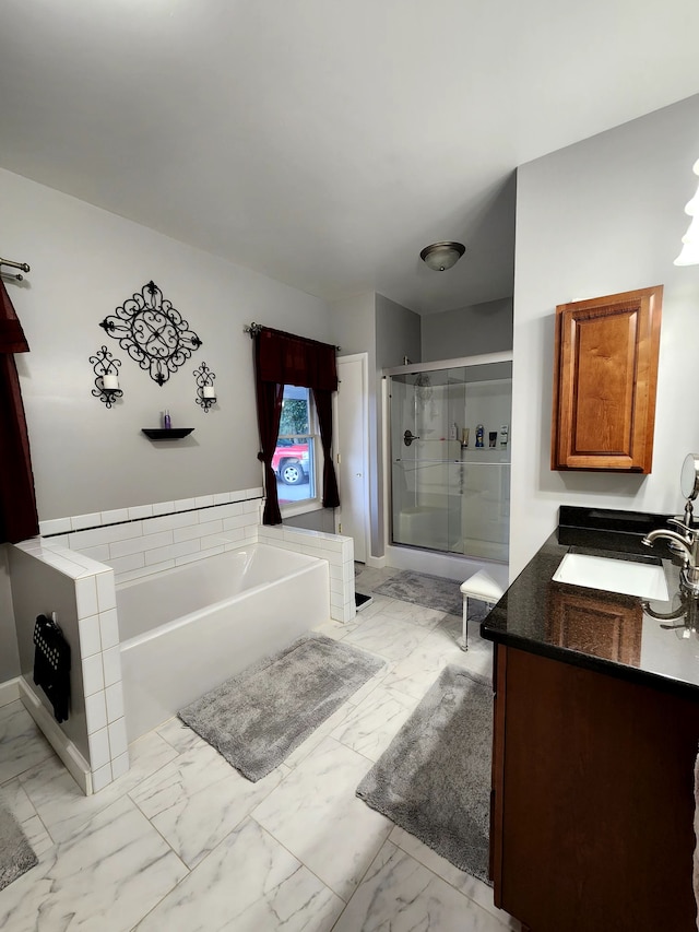 bathroom with vanity and independent shower and bath