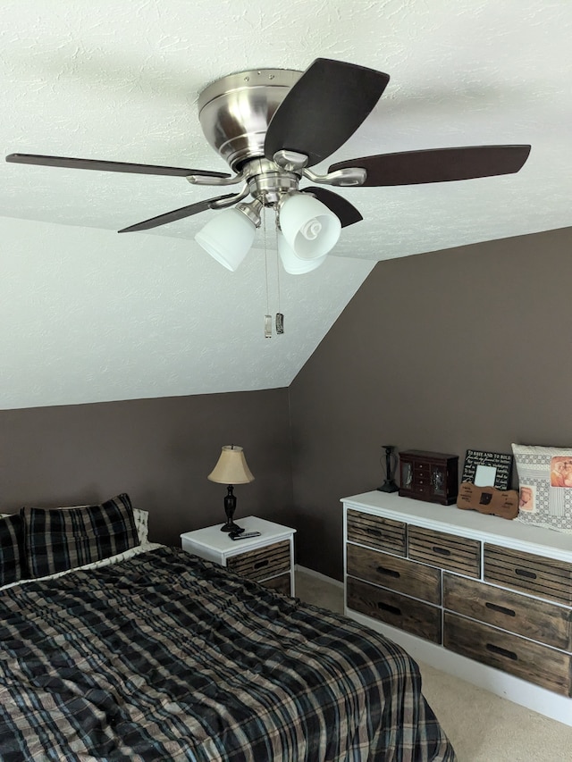 carpeted bedroom featuring a textured ceiling, ceiling fan, and vaulted ceiling