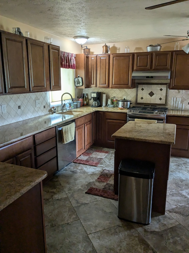 kitchen with a center island, sink, appliances with stainless steel finishes, and tasteful backsplash