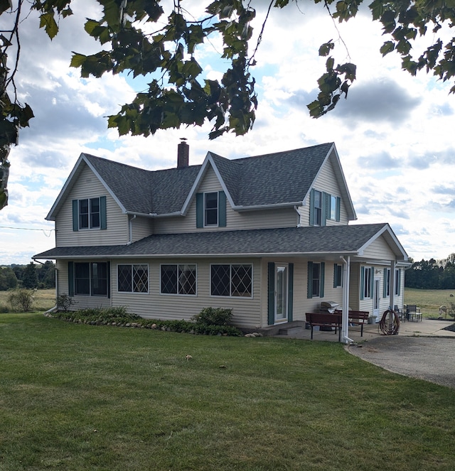 view of front of home featuring a patio area and a front lawn