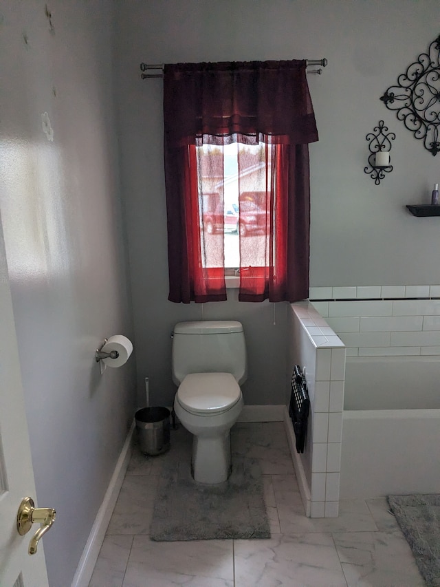 bathroom featuring a bathing tub and toilet