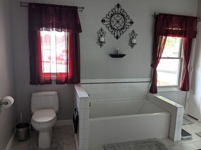 bathroom featuring a bathing tub and toilet