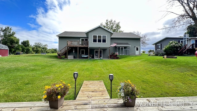 back of house with a yard and a wooden deck