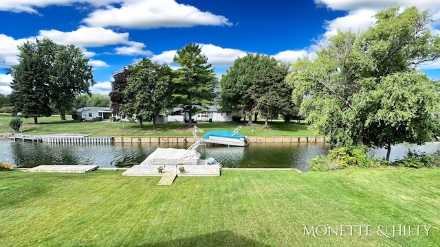 dock area featuring a lawn and a water view