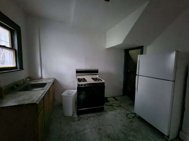 kitchen with white appliances and sink