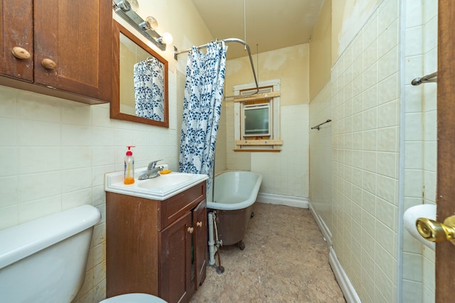 bathroom featuring vanity, tile walls, and toilet